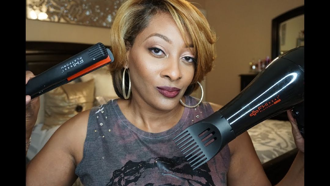 woman holding a fhi straightener and dryer