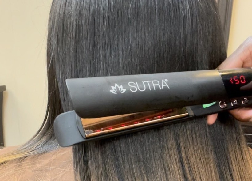 silk pressing hair with flat iron