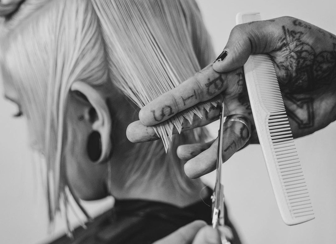 hairstylist cutting burnt hair