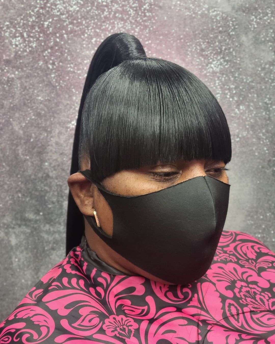 Sleek ponytail with bangs