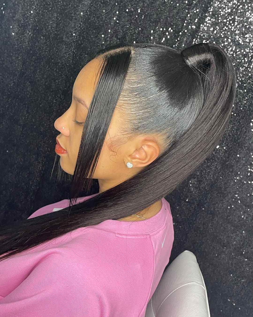 Sleek ponytail with bangs